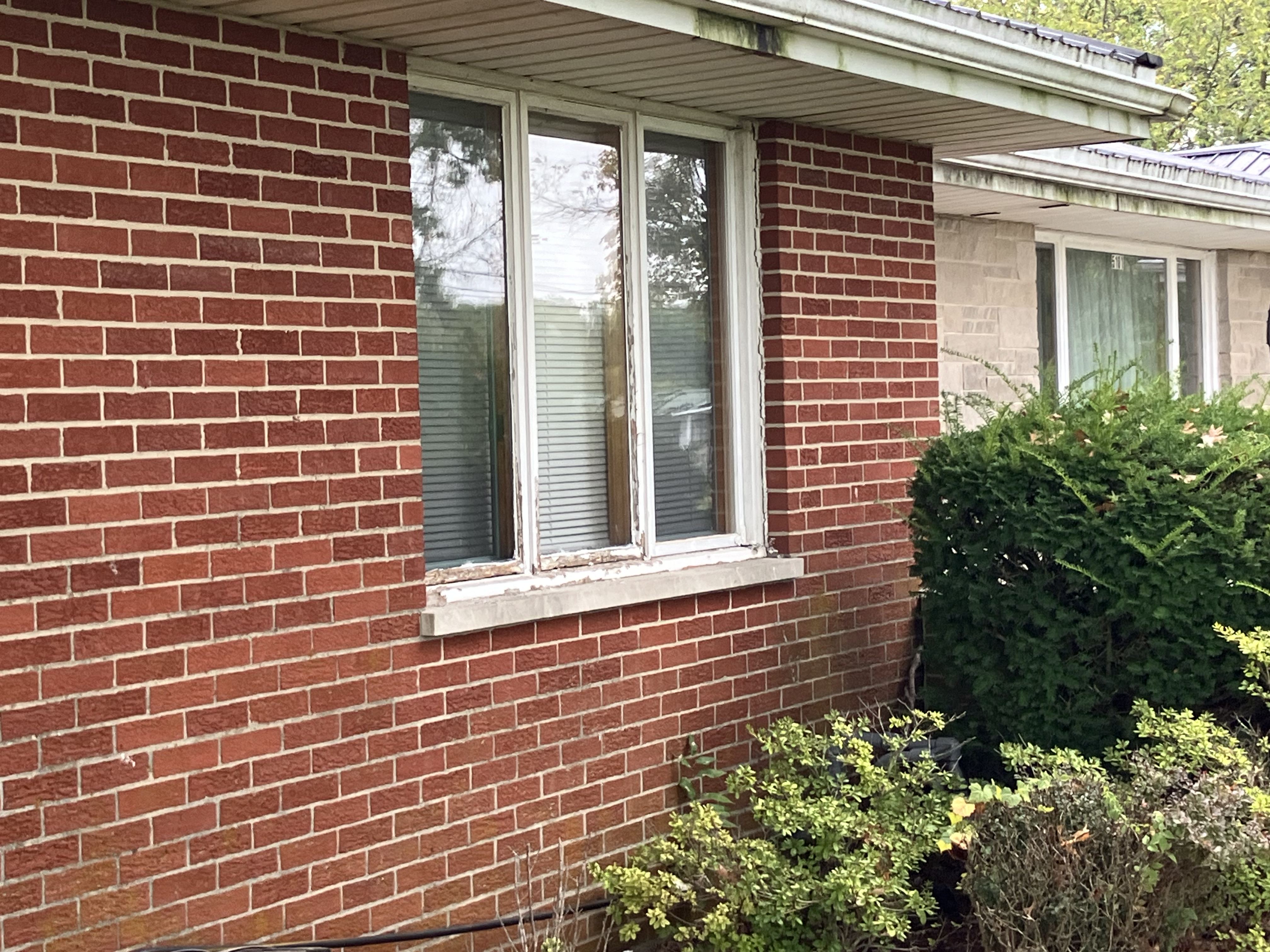 Weathered three-panel window before replacement