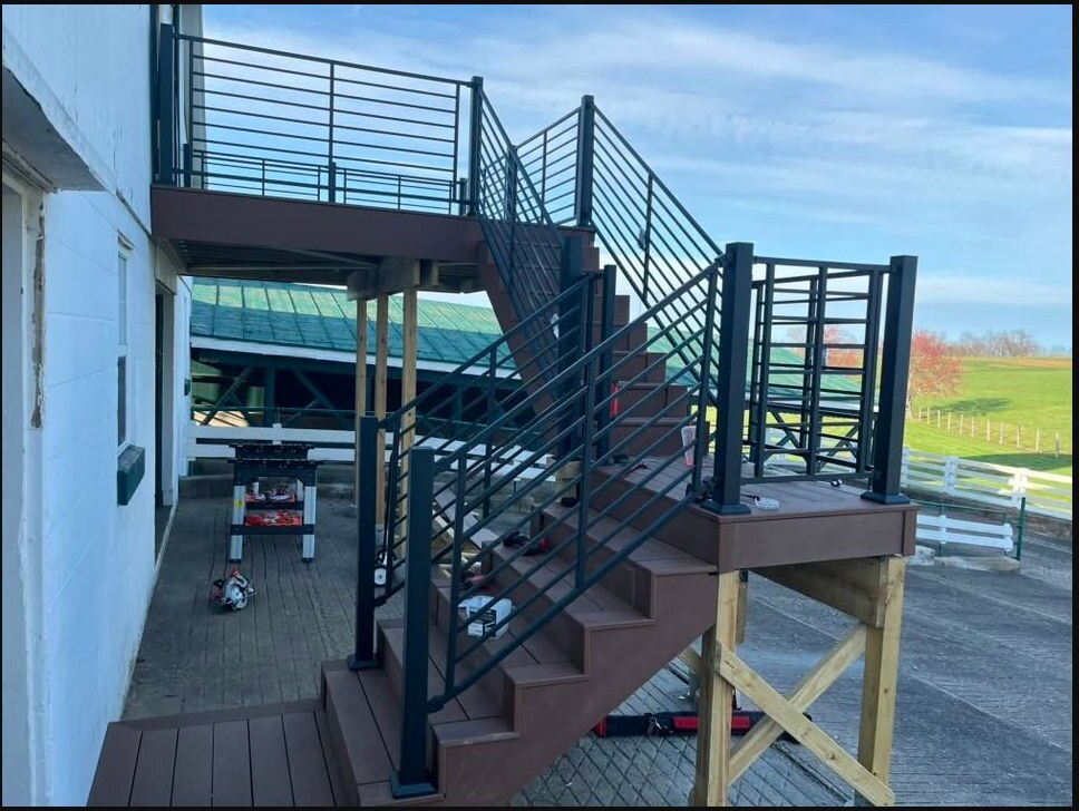 Finished elevated deck and stairs with black metal railing